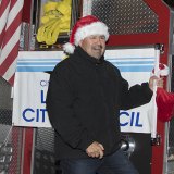 Mayor Ray Madrigal rides the fire truck.